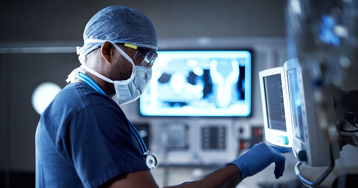 Doctor looking at monitor in operating room